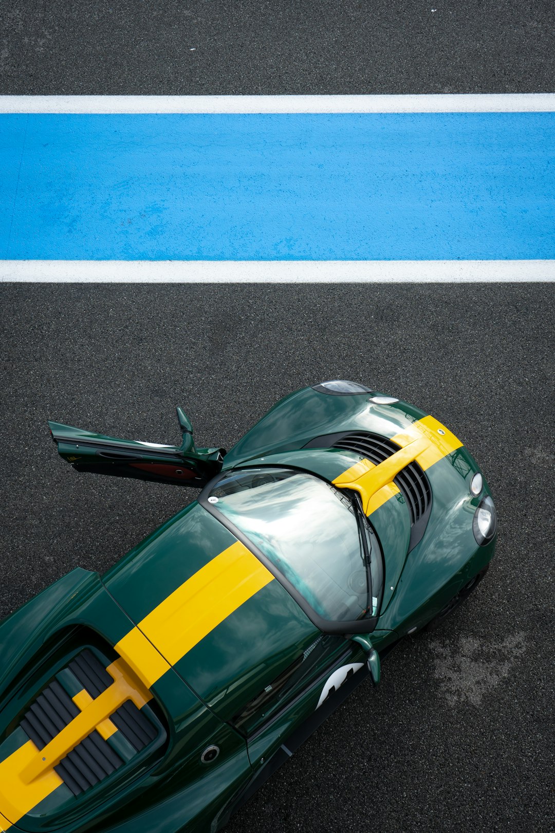 green and yellow car on road green and yellow car on road