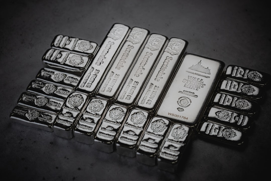 a pile of silver bars sitting on top of a table